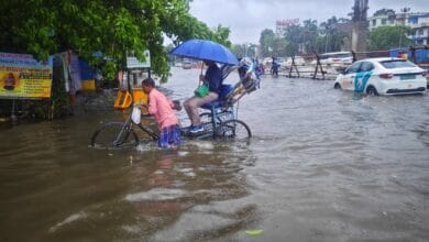 A busy street in Kolkata waterlogged due to heavy monsoon rains.